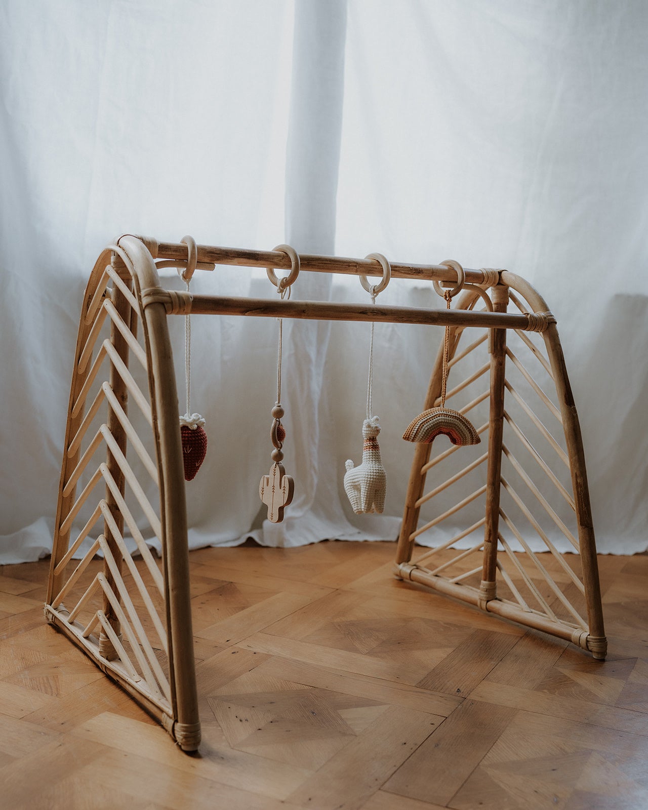 Rattan baby play gym with hanging toys