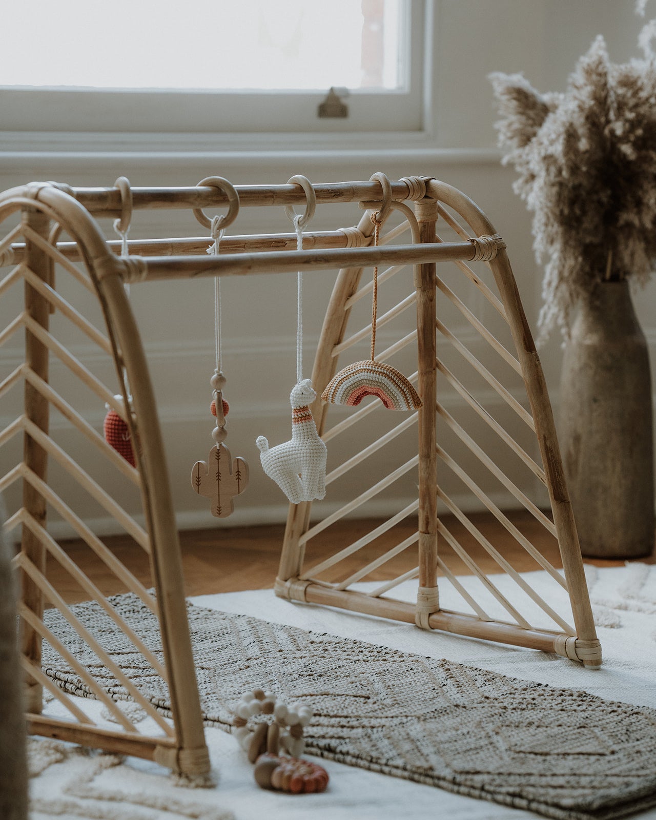 Rattan baby play gym with hanging toys