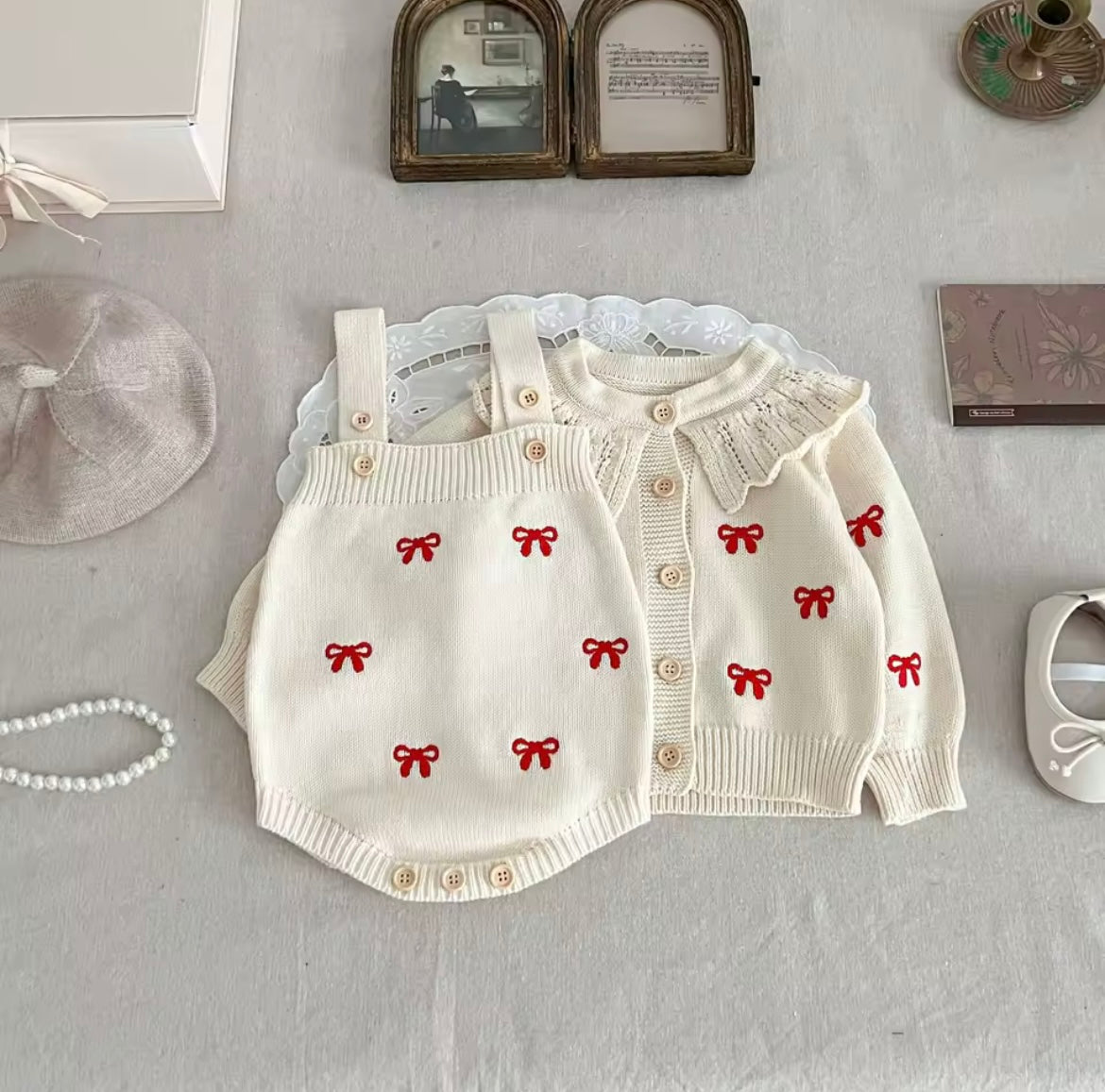 Cream cardigan and romper with red bow detail