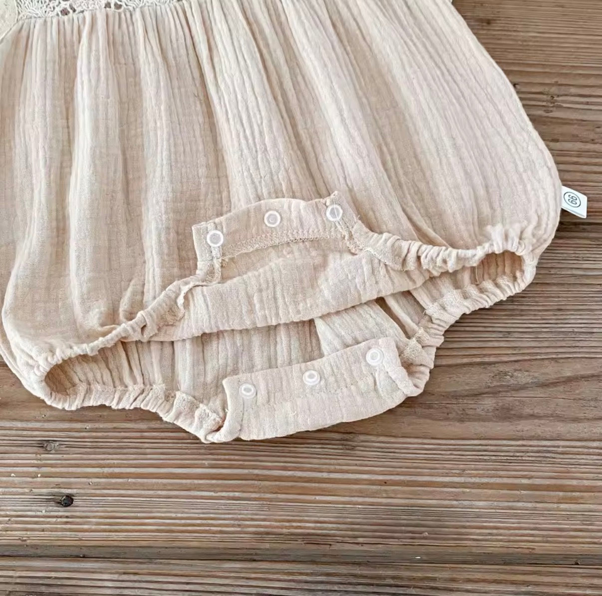 Beige crochet baby romper