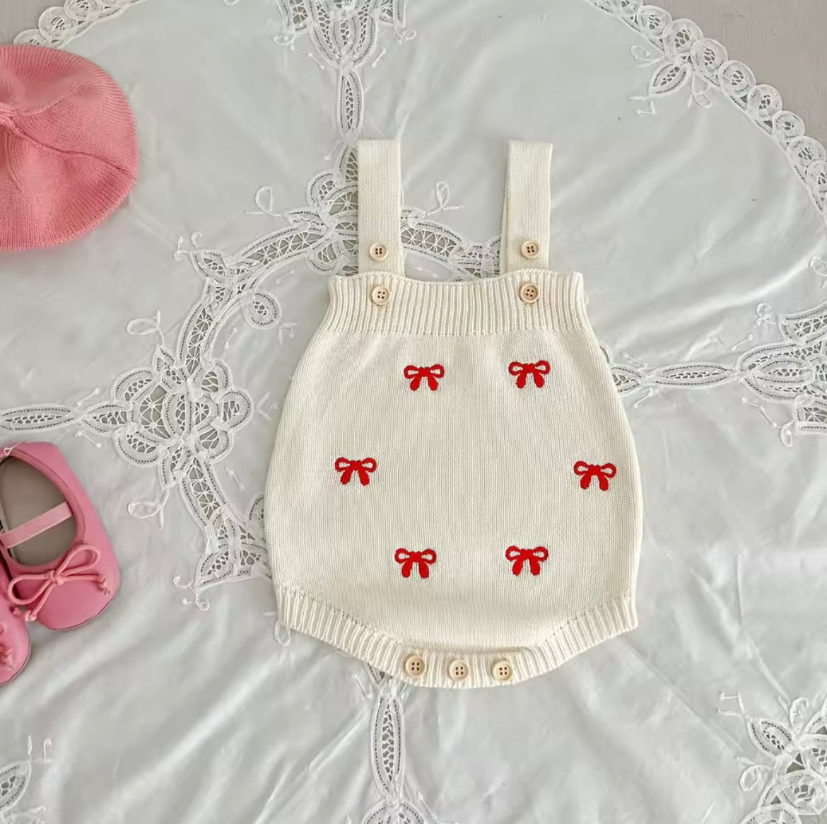 Cream cardigan and romper with red bow detail