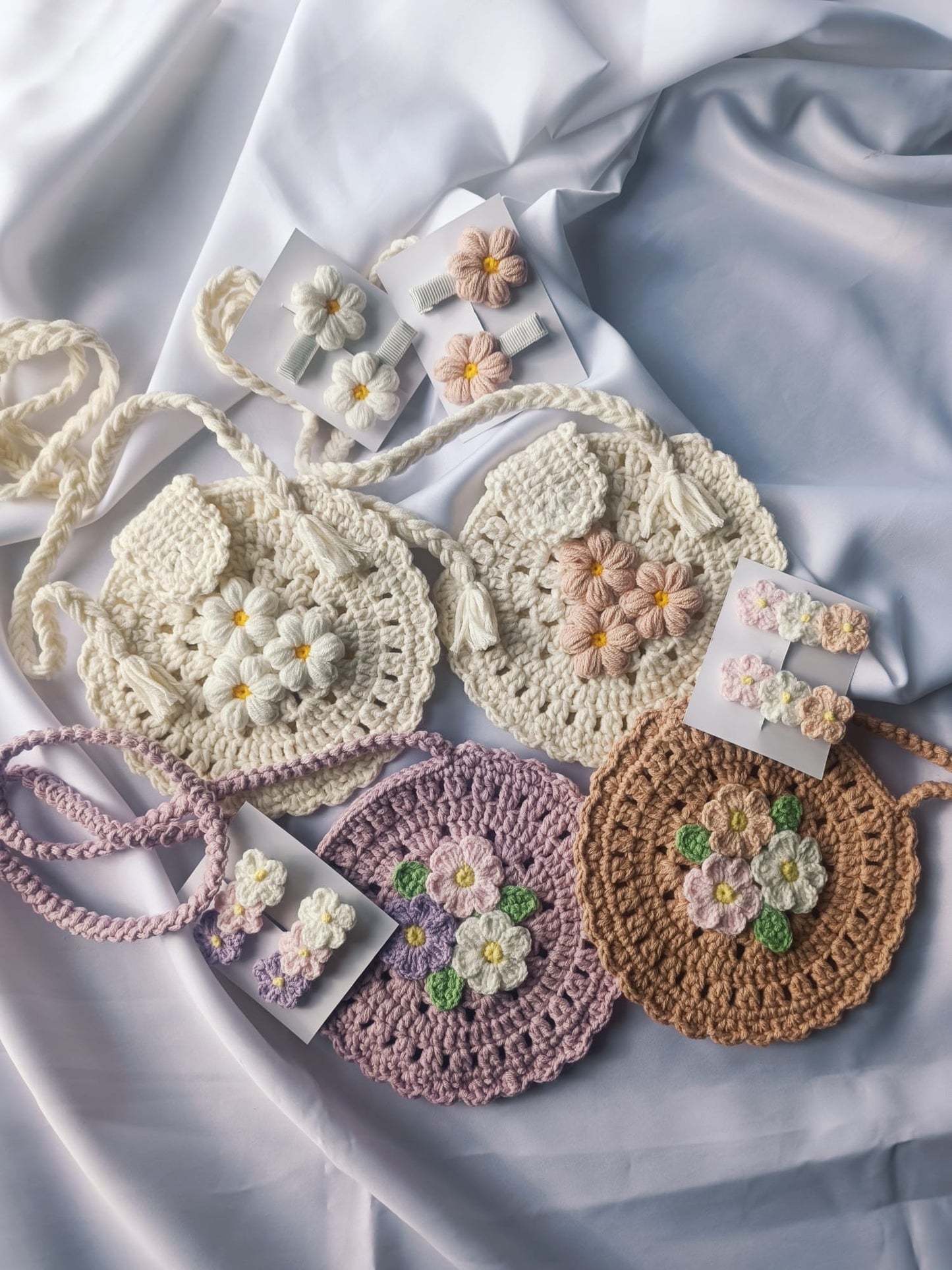 Hand knitted round baby bag and clips set